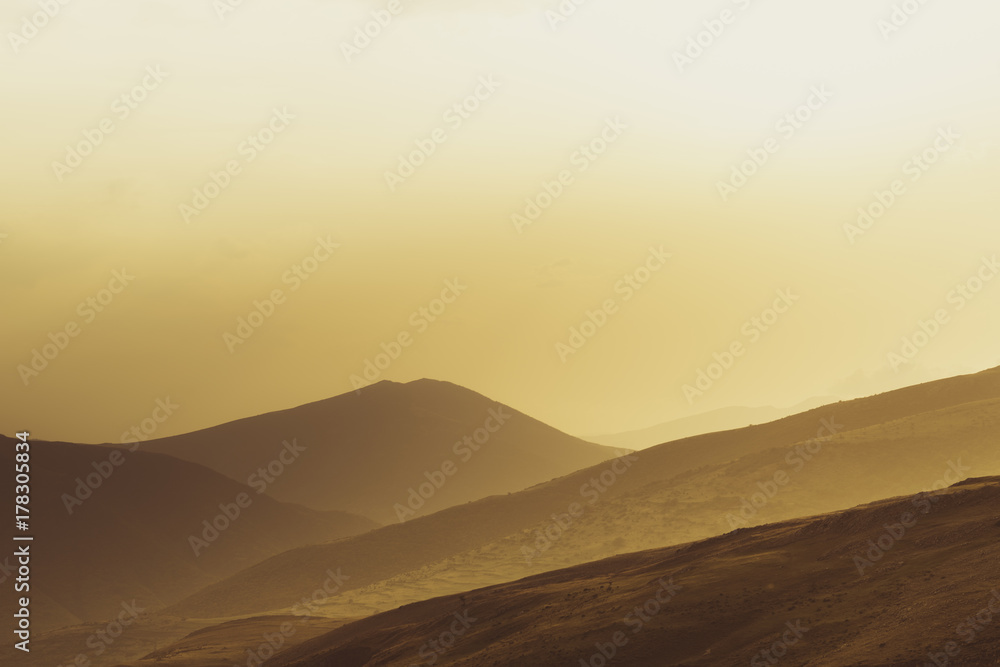 silhouettes of mountains with red light