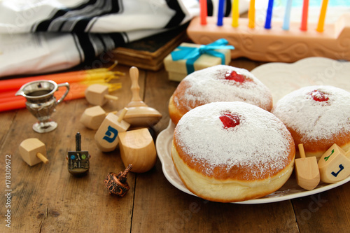 image of jewish holiday Hanukkah background with traditional spinnig top, doughnuts and menorah (traditional candelabra).