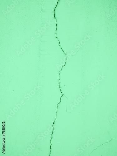 Green wall with cracks