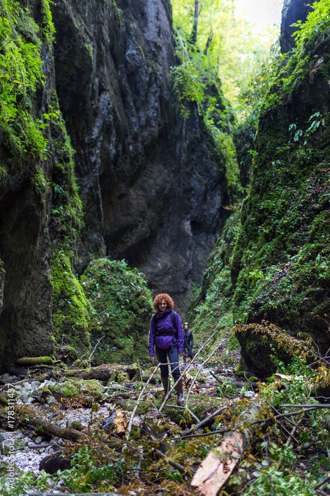 Hiker woman on a trail by the river Hiker woman on a trail by the river