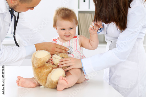 Doctor and patient. Happy cute baby at health exam. Medicine and health care concept