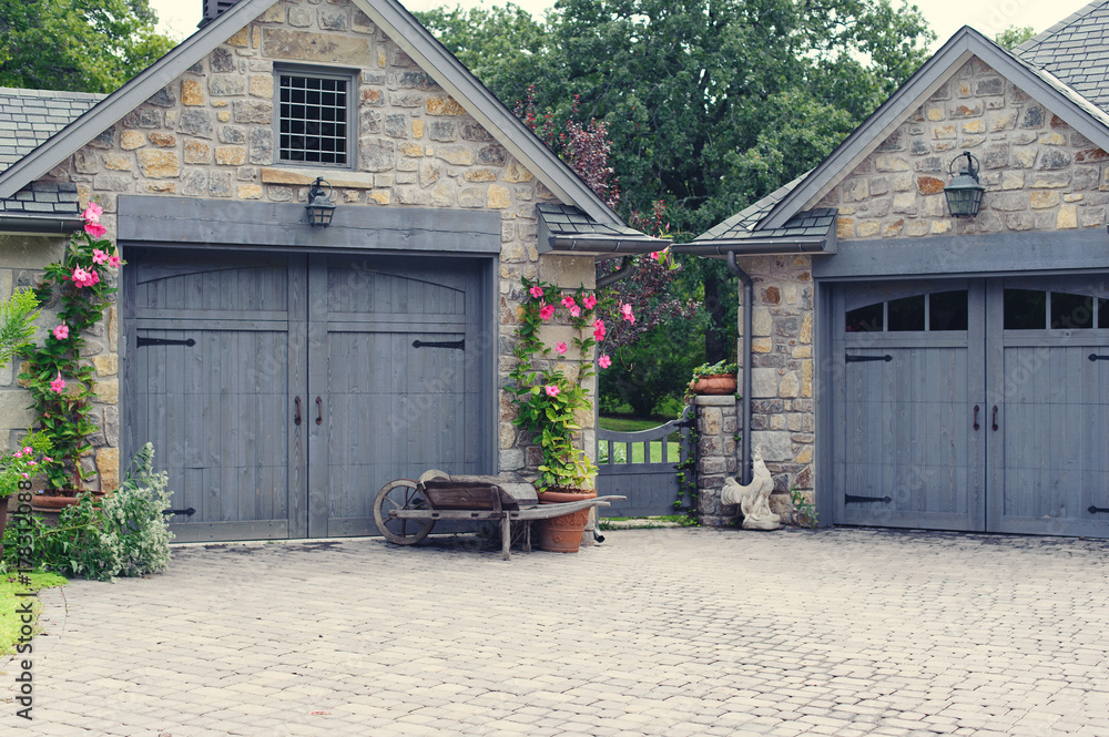 Гараж в деревне фото English Cottage Garage Doors with Gate Between фотография Stock Adobe Stock