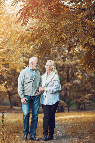 Happy senior couple smiling outdoors in nature  © Tijana
