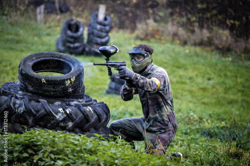 Paintball player aiming and hiding photo