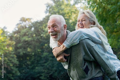 Happy senior couple smiling outdoors in nature  photo