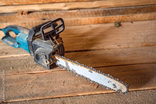 Chainsaw on lumber background