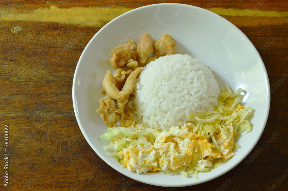 fried cabbage with egg and salty chicken on rice