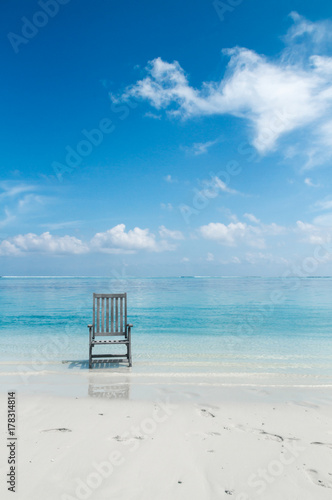 Lonely Chair on a white sanded beach photo