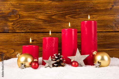 red advent candles with balls and stars