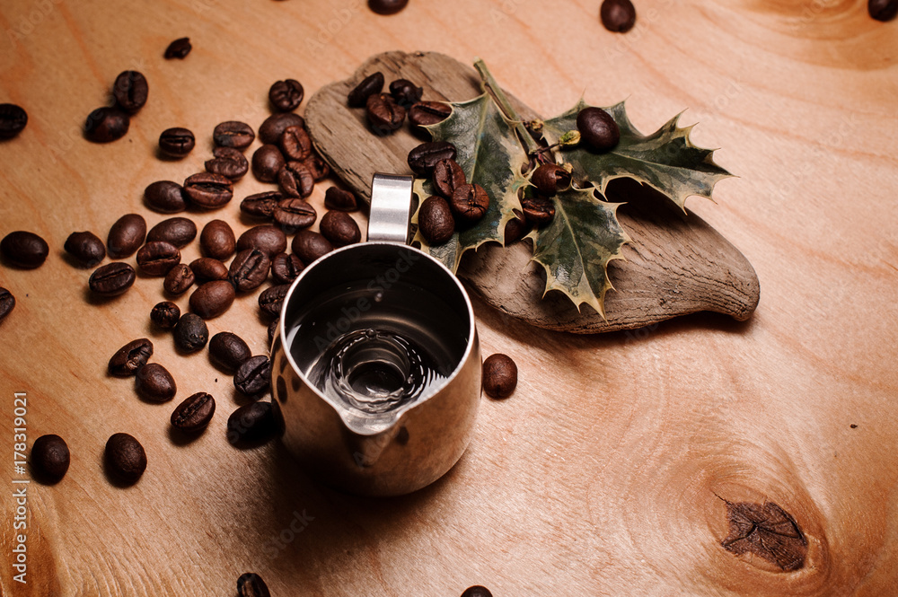 Pitcher with water among fresh coffee beans and dried plants Pitcher with water among fresh coffee beans and dried plants