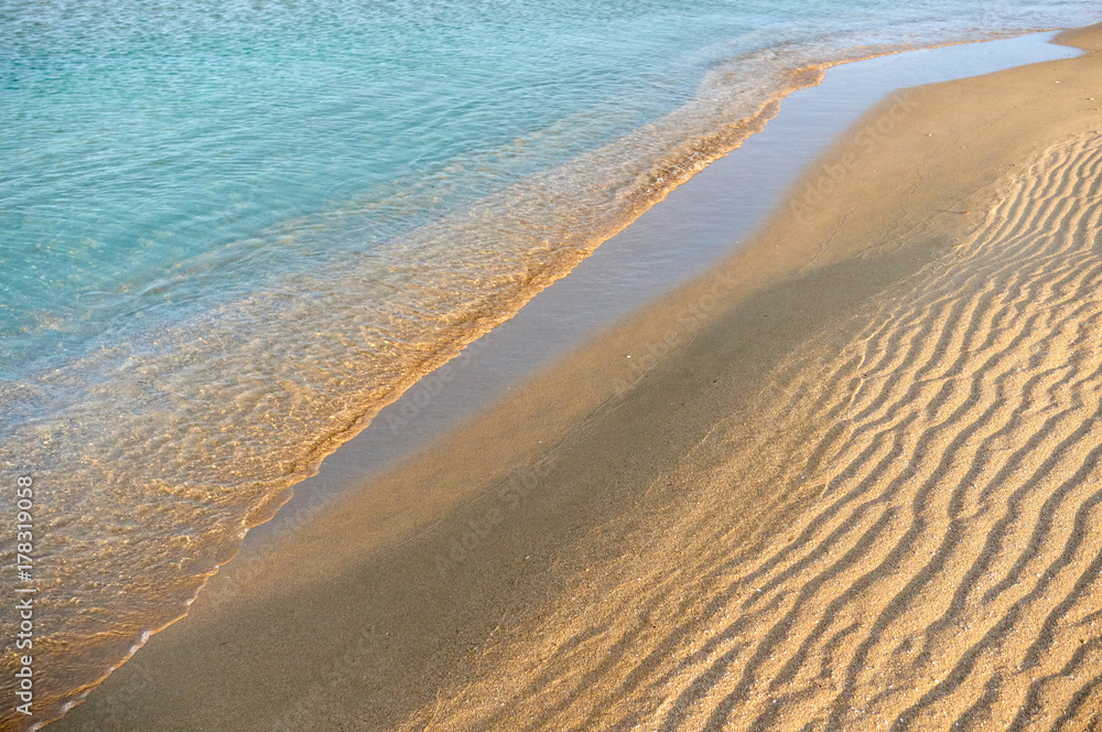 Sands on the beach. A beach is a landform along a body of water. It
