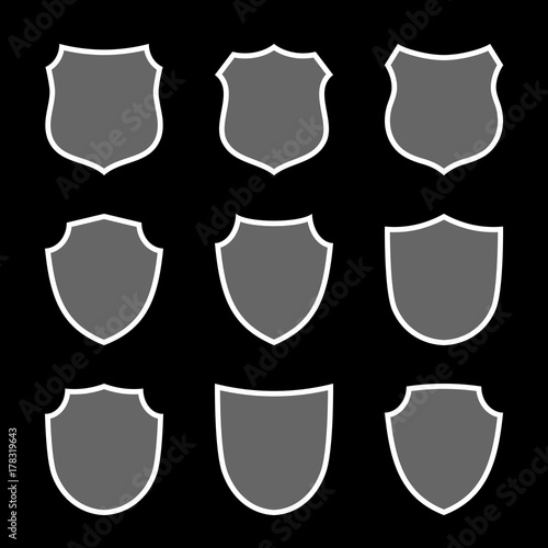 Shield shape icons set. Gray label sign, isolated on black. Symbol of protection, arms, coat honor, security, safety. Flat retro style design. Element vintage heraldic emblem Vector illustration