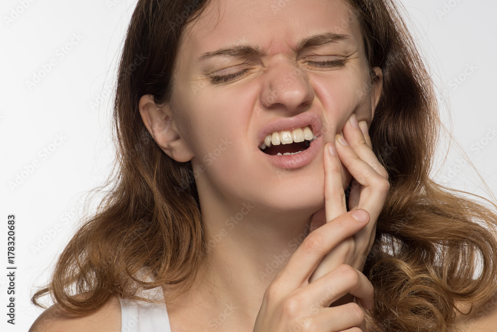 Young beautiful giirl on white background with toothache Young beautiful giirl on white background with toothache