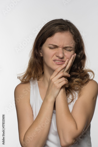 Young beautiful giirl on white background with toothache