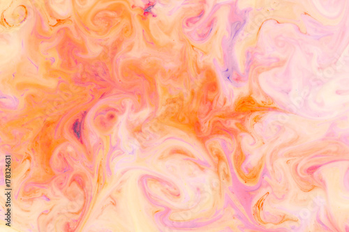 Artistic abstract design created with mixing color liquids. Colorful background texture. Liquids mixing on water surface