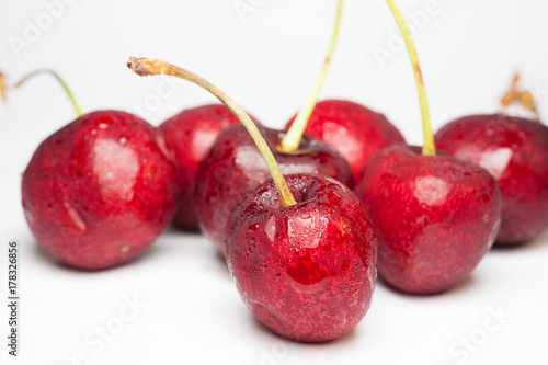 Ripe cherry in closeup on white background.