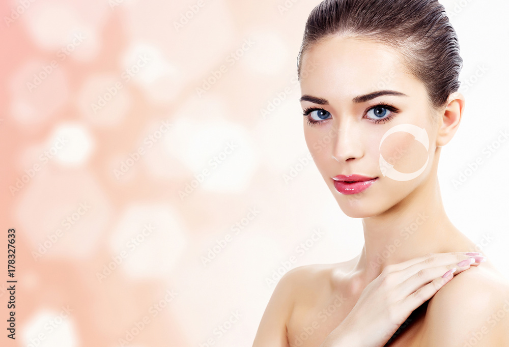 Young beautiful woman touches her shoulder, antiaging concept, abstract background with blurred lights Young beautiful woman touches her shoulder, antiaging concept, abstract background with blurred lights