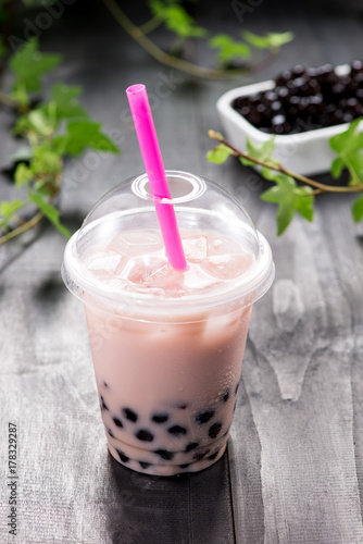 Bubble boba tea with milk and tapioca pearls in plastic cup