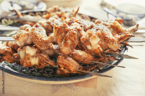 Delicious marinated wings grilled served on a ceramic dish. Fast food.