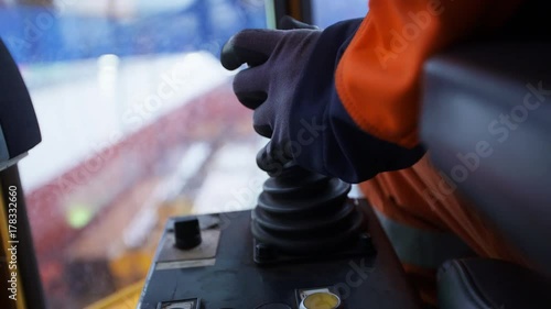 Crane operator operating joystick, close up