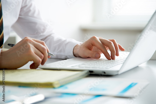 Close-up of hands of business man typing on a laptop.