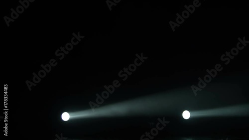 Realistic footage of stage light flashing rays spotlights through smoke. Great as a natural stage background for different projects!!! photo