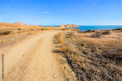 View of road  sea  mountains and sky