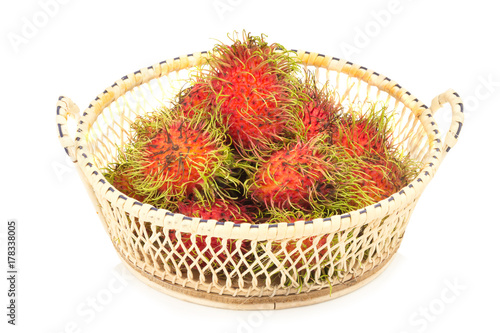 rambutan in basket isolated on white background