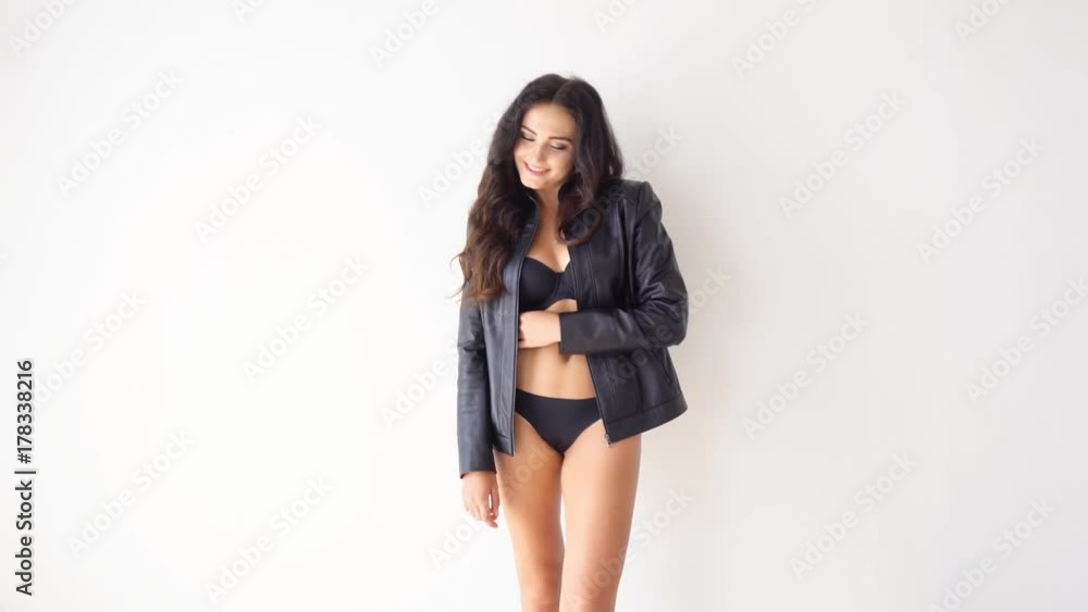 brunette girl in black lingerie posing on a white background brunette girl in black lingerie posing on a white background