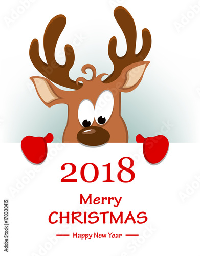 Merry Christmas greeting card with funny reindeer hiding behind placard with greetings