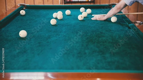 Wallpaper Mural Man with a cue in his hands aims at the ball close up Torontodigital.ca