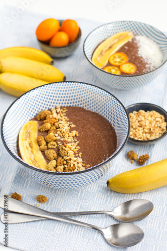 Trendy chocolate chia bowls with banana, mulberries and nuts