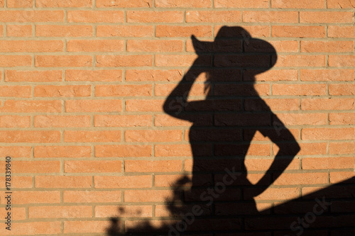 cowgirl silhouette on brick wall - country line dance
