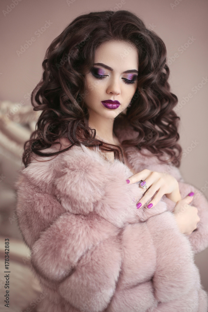 Luxury girl in pink fur coat. Beauty makeup. Brunette with long curly hairstyle, elegant fashion glamour woman. Beautiful lady portrait. Luxury girl in pink fur coat. Beauty makeup. Brunette with long curly hairstyle, elegant fashion glamour woman. Beautiful lady portrait.