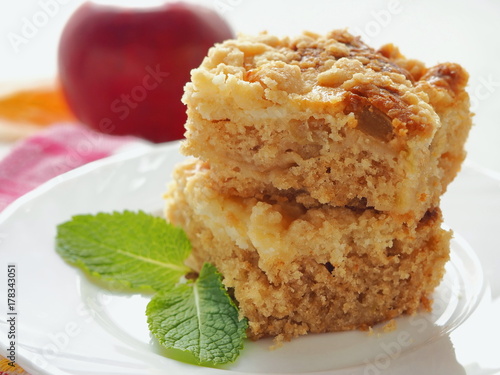 Two pieces of coffeecake on white plate. Fresh crumble pie with streusel topping. Selective focus.