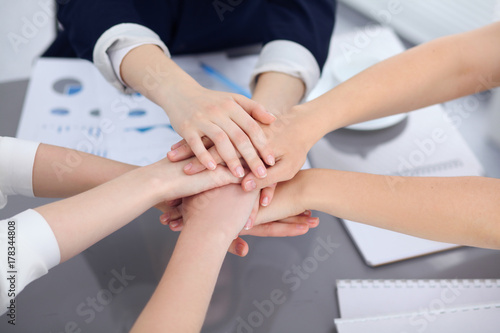 Unknown business people joining hands, close-up. Teamwork concept