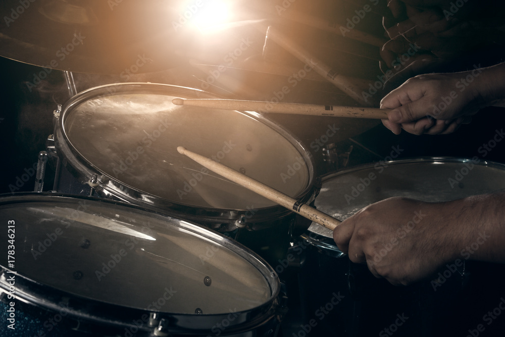 The man is playing drum set. The man is playing drum set.