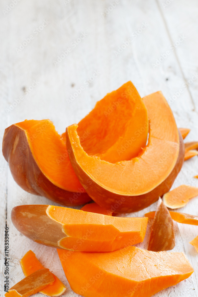 Pumpkin slices on a wooden background