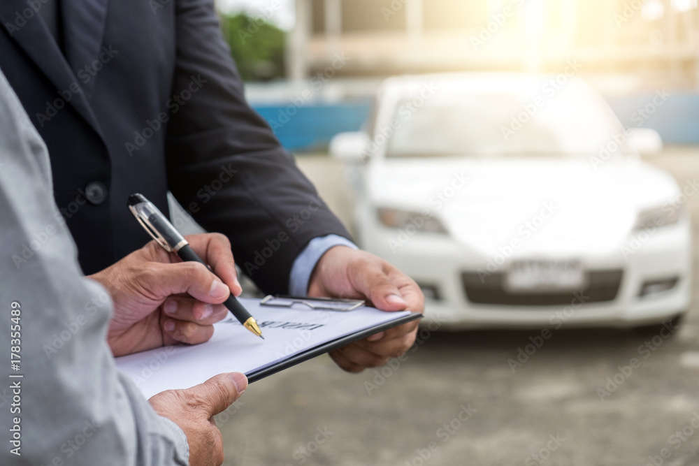 Fototapeta premium Insurance Agent examine Damaged Car and customer filing signature on Report Claim Form process after accident, Traffic Accident and insurance concept