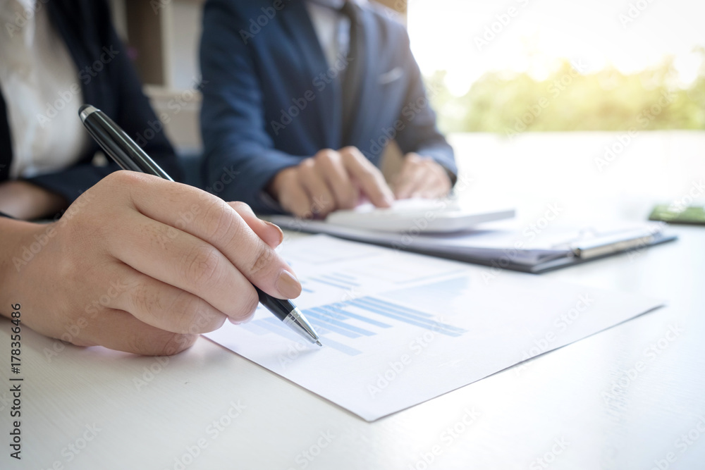 Business team two executive colleagues discussing and analysis working Financial investment on calculator with calculate on tablet Analyze business and market growth on financial document data graph Business team two executive colleagues discussing and analysis working Financial investment on calculator with calculate on tablet Analyze business and market growth on financial document data graph