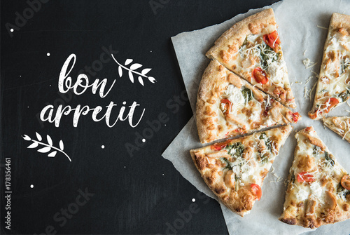 traditional italian sliced pizza on parchment photo