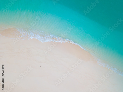 Summer Beach top view or aerial view showing shade of emerald water and wave
