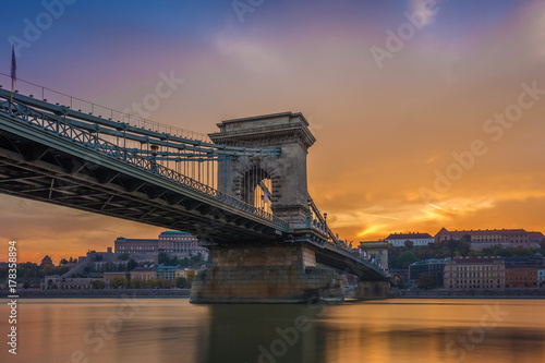 Budapest, Hungary - The beautiful Szechenyi Chain Bridge and Buda Castle Royal Palace with amazing colorful sunset and sky