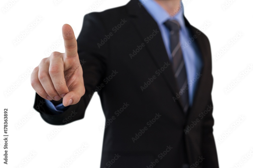 Mid section of businessman touching index finger on invisible Mid section of businessman touching index finger on invisible