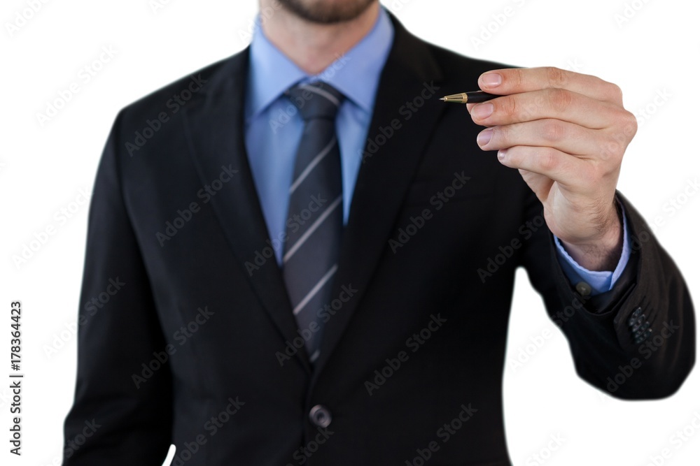 Mid section of businessman writing on invisible interface Mid section of businessman writing on invisible interface