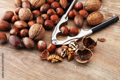 Large diversity of healthy nuts on wooden background.