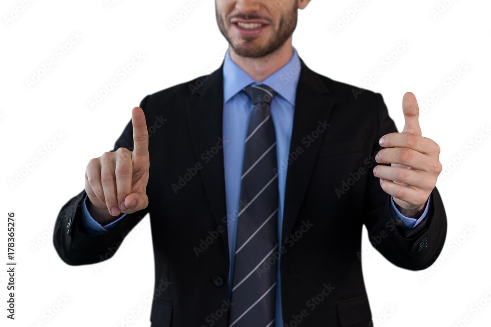 Mid section of businessman wearing suit while using invisible Mid section of businessman wearing suit while using invisible