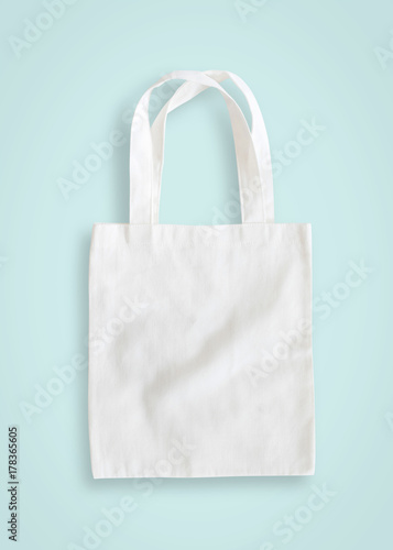 Tote bag mock up canvas fabric cloth shopping sack on blue background isolated with clipping path