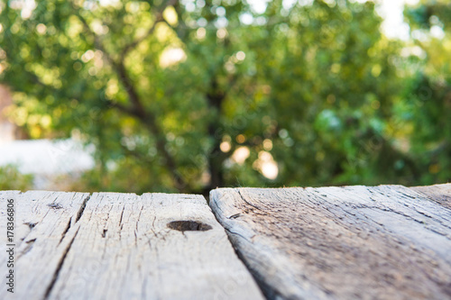 Wooden empty table and blurred green background