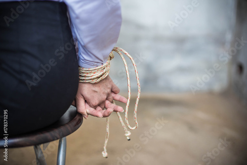 ฺBack view of a business woman with a rope